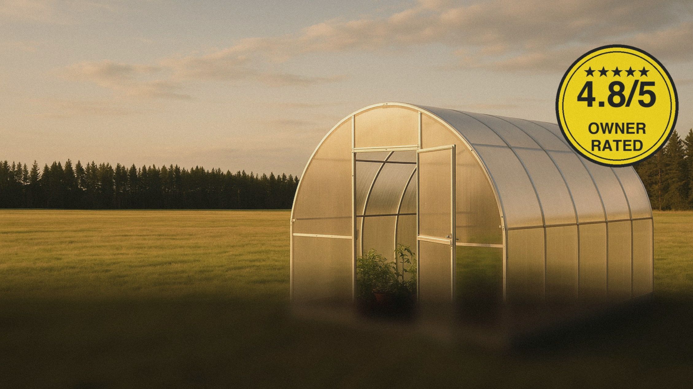 Arch Pro polycarbonate greenhouse in an open field at golden hour