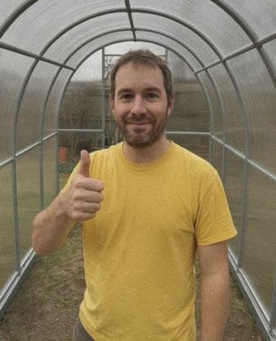 Customer inside his assembled greenhouse